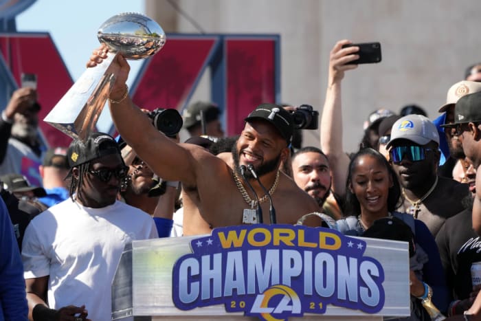 Feb 16, 2022; Los Angeles, CA, USA; Los Angeles Rams defensive end Aaron Donald holds the Vince Lombardi trophy during the Super Bowl LVI championship rally at the Los Angeles Memorial Coliseum. Mandatory Credit: Kirby Lee-USA TODAY Sports